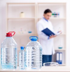 Fototapeta premium Young male chemist experimenting in lab