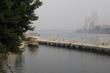 Fototapeta na wymiar The Nile, fog, cityscape, skyscrapers
