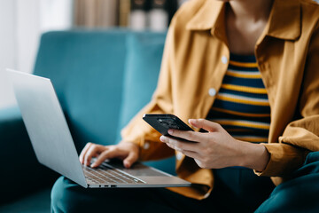 Confident businesswoman working on laptop,tablet and smartphone at her workplace at office..