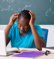 Black female student in front of chalkboard