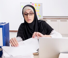 Female employee in hijab working in the office