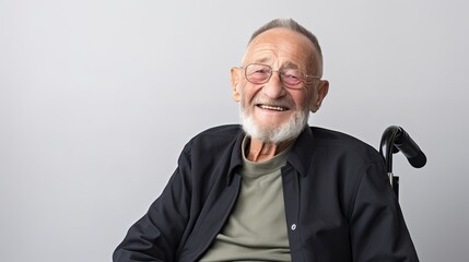 Portrait of a happy senior man sitting on wheelchair. Cheerful old man sitting on wheelchair. Disabled man in his wheelchair looking at camera.