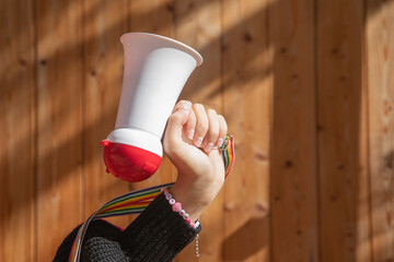 Caucasian young woman holding megaphone.