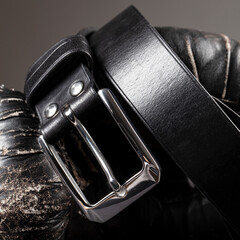 Part of a black crocodile leather belt. Expensive leather goods.