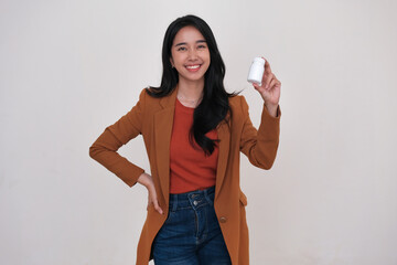 Cheerful expression of an Asian woman showing medical capsules in plastic container