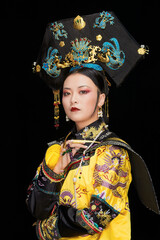 A Asian woman dressed in Qing Dynasty Empress attire