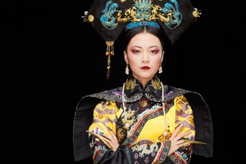 A Asian woman dressed in Qing Dynasty Empress attire