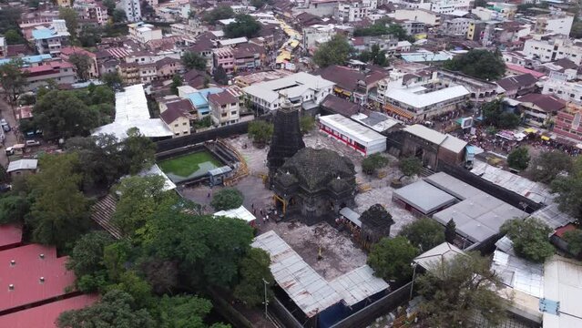 Aerial view of sacred Trimbakeshwar Jyotirling Temple dedicated to Lord Shiva with pilgrims and devotees on the street during Shravana month, Trimbak City, Nashik, Maharashtra, India