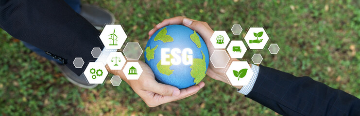 Two businessmen's hand holding planet Earth together symbolize ESG business partnership invest on...