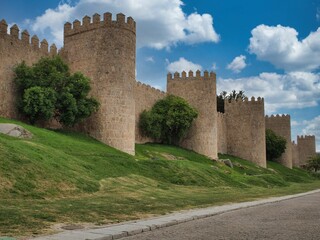 Fototapeta na wymiar the old stone wall near the road, Avila Walls, Spain