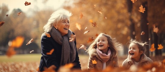 Inter generational family enjoys autumn park tossing leaves and having fun