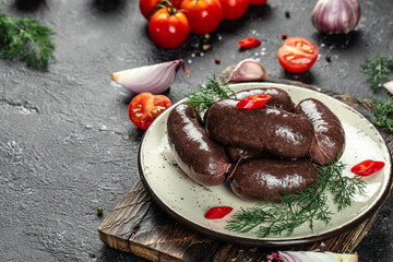 blood sausage, Spanish black pudding on a dark background. top view. place for text