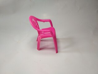 Pink plastic chair isolated on a white background. Plastic chair for children.