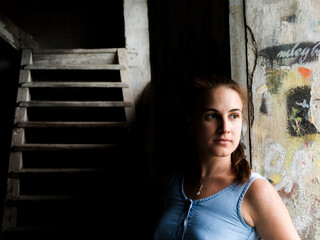 Fototapeta premium Young woman in a ruined house