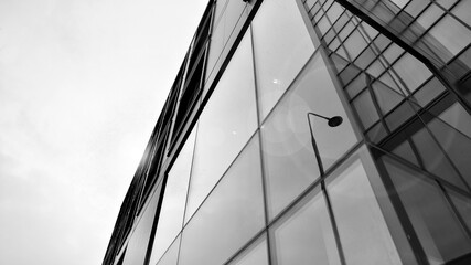 Obraz premium Abstract reflection of modern city glass facades. Modern office building detail, glass surface. Black and white.