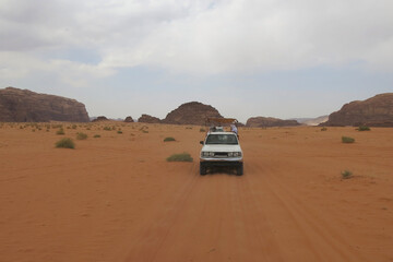 OffRoad Vans Carrying Passengers and Equipment Across Desert Terrain