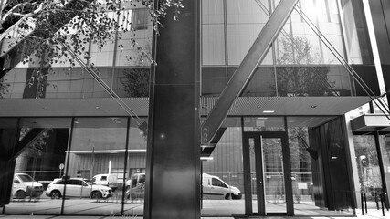 Combination of metal and glass wall material. Steel facade on columns. Abstract modern architecture. High-tech minimalist office building. Black and white.