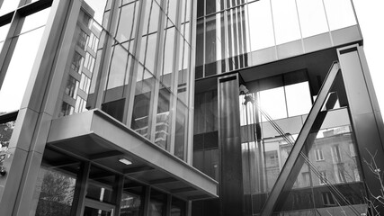 Combination of metal and glass wall material. Steel facade on columns. Abstract modern architecture. High-tech minimalist office building. Black and white.