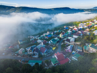 View Dalat city on the foot of Langbian mountain in misty day - Ariel view 