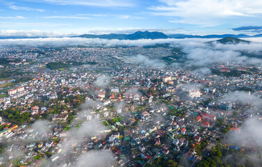 View Dalat city on the foot of Langbian mountain in misty day - Ariel view 