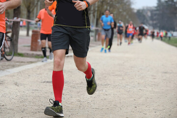 Red-Socked Athlete s Sprint in the Park During Footrace Competition