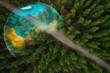 Aerial view of road and green pine forest and soil. electric train concept Use renewable energy and...