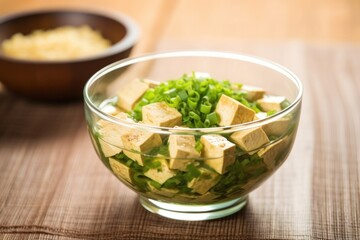 raw tofu in an asian-inspired marinade in a glass bowl