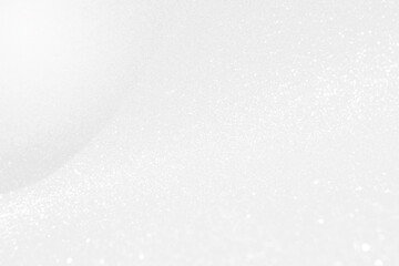 Abstract blurred white glitter background, selective focus, festive background idea