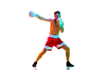 Fototapeta na wymiar Emotional man, sportsman, boxer, fighter exercising before fight against white background in mixed neon filter, light.