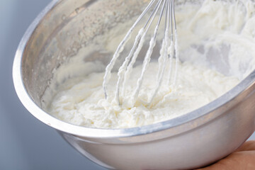 white whipped cream in metal bowl
