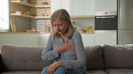 Mature unhealthy caucasian retirement woman grandmother feeling sharp chest pain symptom heart...