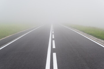 Asphalt road in the heavy fog with clear road markings, Pieniny mountains, Poland - 670923255