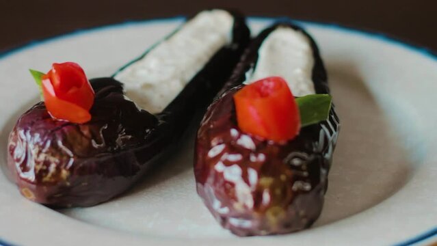 food art, eggplant in shoe form and yoghurt inside, traditional Turkish and Greek appetizer Haydari