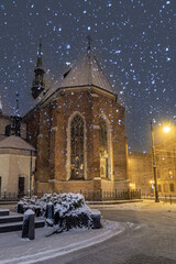 St Francis church in the night during snowfall, Krakow, Poland