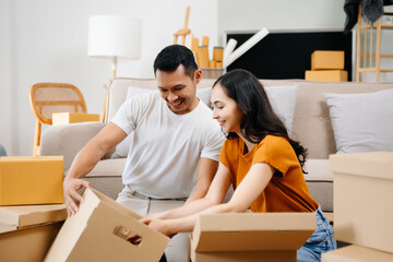 Asian young attractive couple man and woman use tablet and smartphone online shopping furniture...