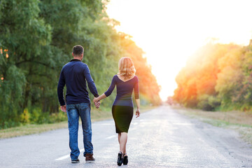 A Happy couple in love on the road in the park on nature travel