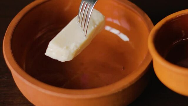 Appetizer preparation, mash white cheese with a fork and mix with yoghurt