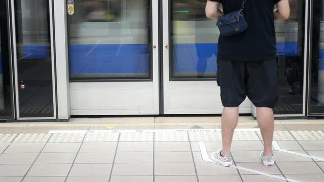 low angle view to the entrance door gate of the subway flatform station while train commuter approaching