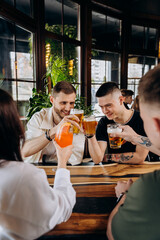 Beverage lifestyle concept with guys and girls having fun together at brewery bar restaurant