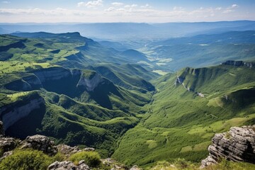 view from a mountains peak overlooking a valley