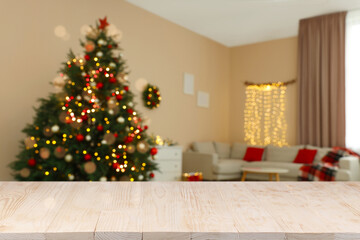 White wooden table in room decorated for Christmas. Space for design