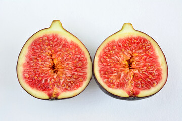 two halves of fig fruit isolated on white background  