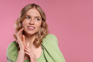 Fototapeta premium Portrait of beautiful woman with blonde hair on pink background. Space for text