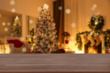Fototapeta na wymiar Wooden table in room decorated for Christmas. Space for design
