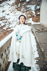 After a heavy snowfall, beautiful women in ancient costumes are seen in the scenic area