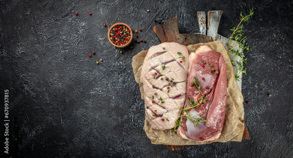 Wall mural fresh duck meat, raw breast steak on a dark background. top view. place for text