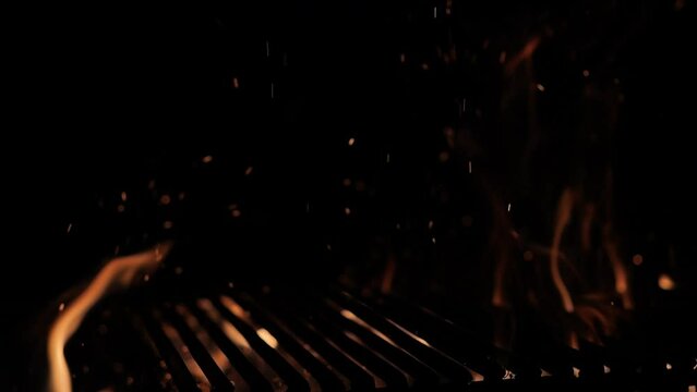 The fire burns through the grill grate. Hellish barbecue. Hearth in the fireplace.