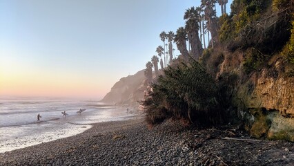 Southern California beach scenes with sunsets, surfers, tide pools and palms trees at Swamis Reef...