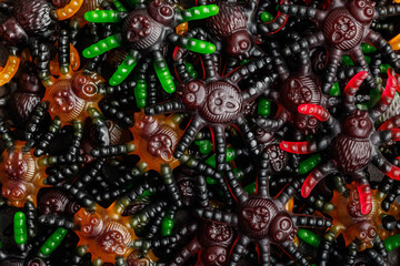 Scary sweet jelly spiders. Halloween candies. Top view.