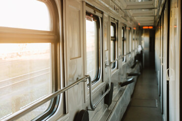 Interior of the train, Travel by railway. Corridor of night sleeping train, Nobody. Empty wagon, cozy and comfortable travel, sunset light coming from the window. 